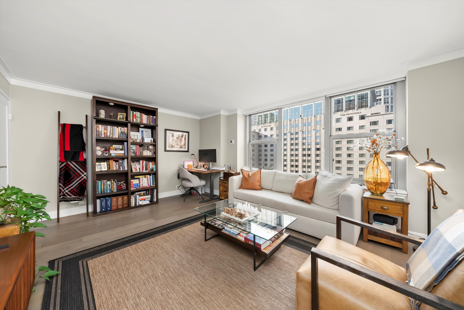 777 North Michigan Avenue, Unit 1601 Chicago, IL 60611 - Photo 22 of 44 a living room with furniture a bookshelf and a large window
