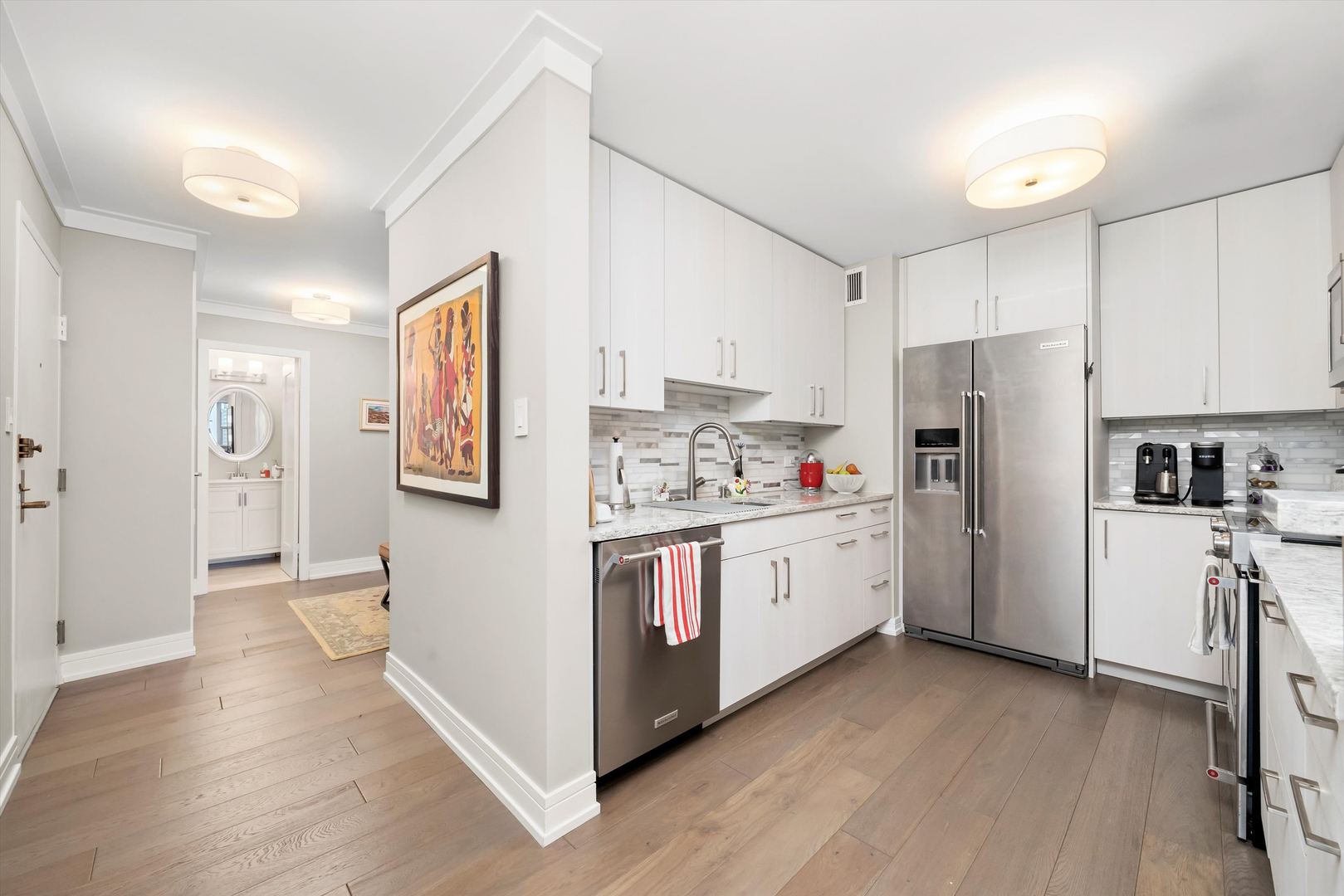 777 North Michigan Avenue, Unit 1601 Chicago, IL 60611 - Photo 4 of 44 a kitchen with cabinets and wooden floor