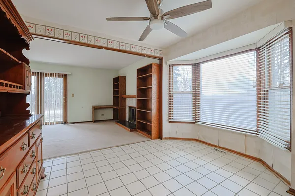 a view of an empty room with a fireplace and a window