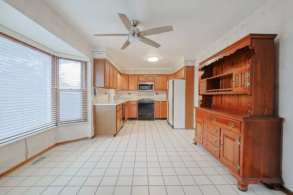 a kitchen with stainless steel appliances granite countertop a refrigerator and a stove top oven