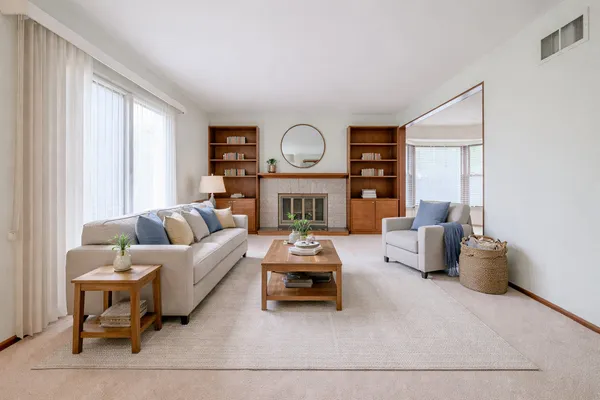 a living room with furniture and a fireplace