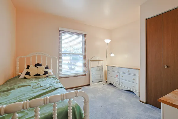 a bed room with a bed and a window
