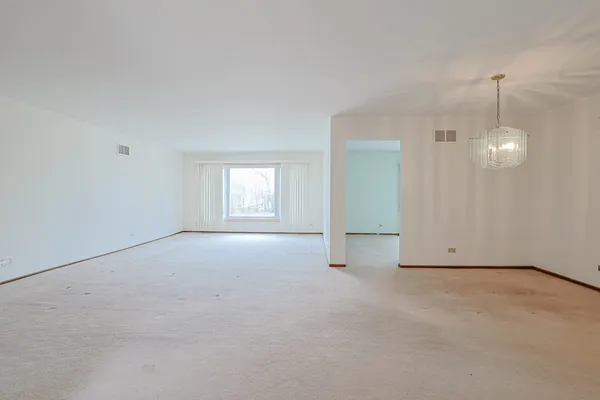 an empty room with a empty space and windows