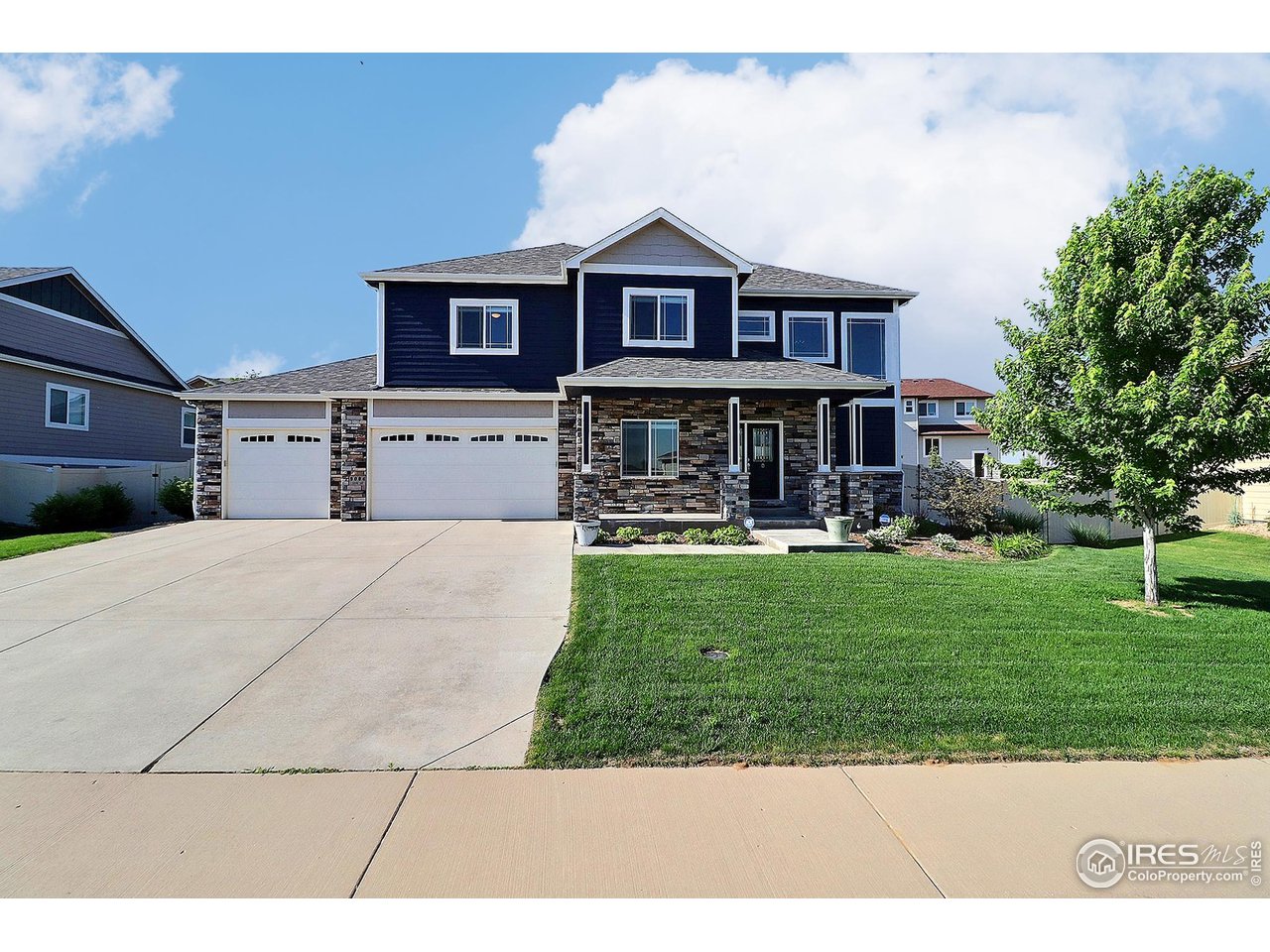 9004 19th Street Greeley, CO 80634 - Photo 1 of 49 a front view of a house with a yard table and chairs