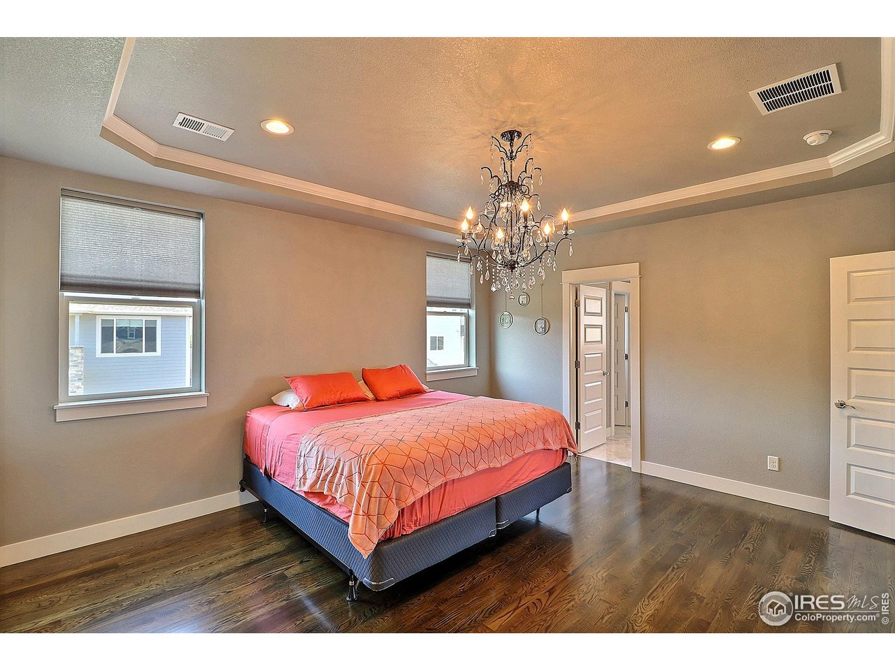 9004 19th Street Greeley, CO 80634 - Photo 26 of 49 a bedroom with a bed and a chandelier