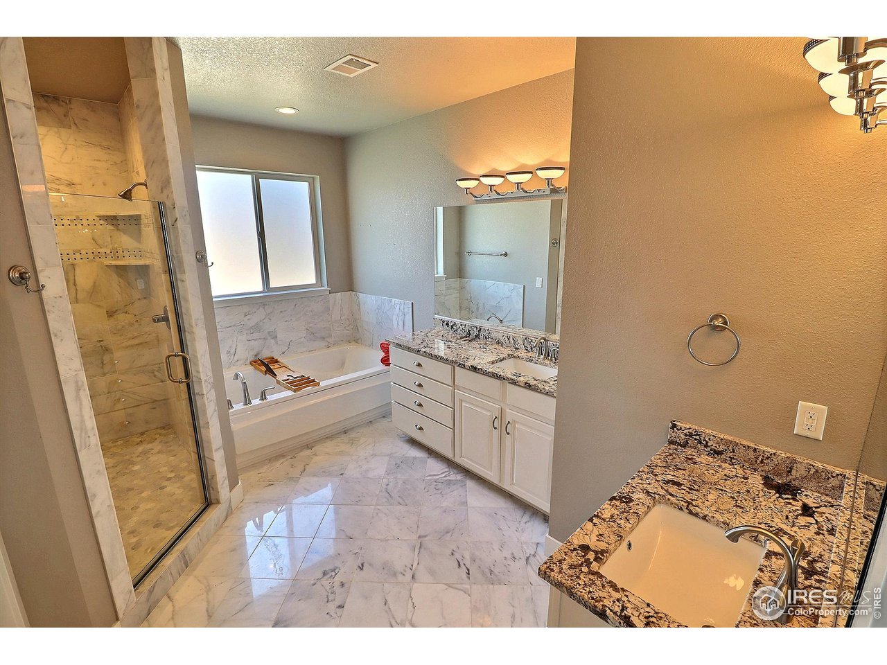 9004 19th Street Greeley, CO 80634 - Photo 29 of 49 a bathroom with a bathtub sink and mirror