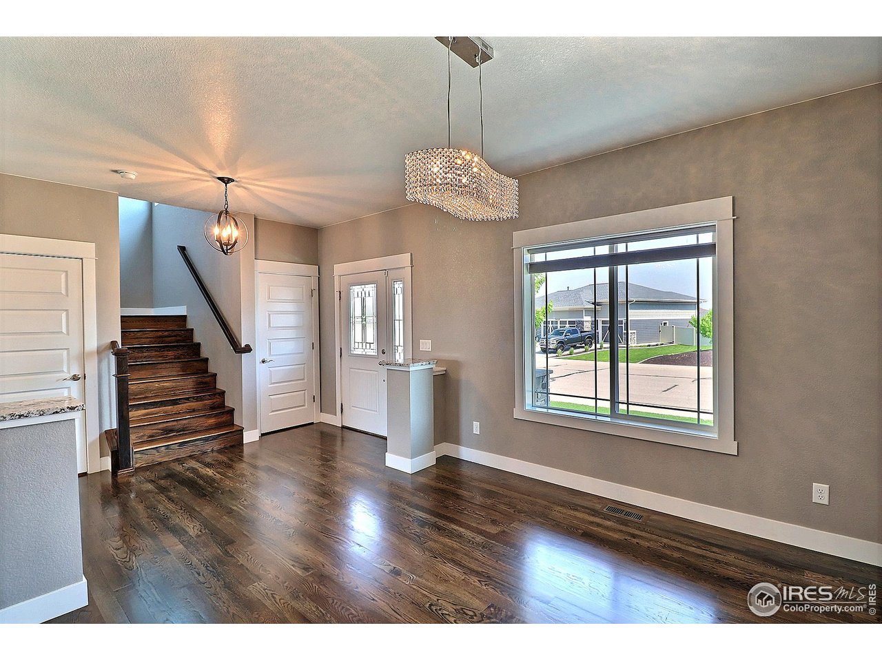 9004 19th Street Greeley, CO 80634 - Photo 3 of 49 a view of an empty room with wooden floor and a window