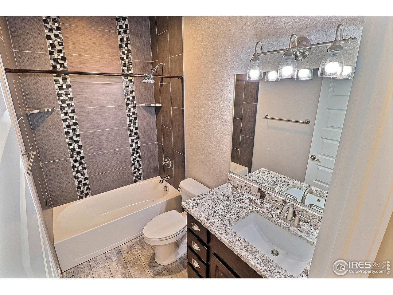 9004 19th Street Greeley, CO 80634 - Photo 35 of 49 a bathroom with a sink a toilet and shower