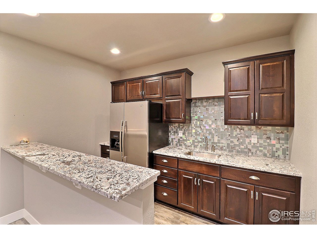 9004 19th Street Greeley, CO 80634 - Photo 38 of 49 a kitchen with stainless steel appliances granite countertop a sink stove and refrigerator