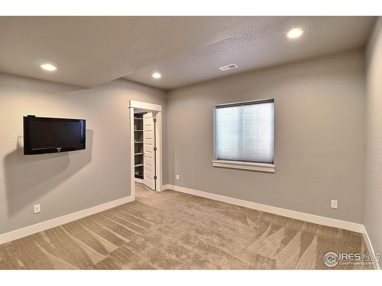 9004 19th Street Greeley, CO 80634 - Photo 41 of 49 a view of an empty room with wooden floor and a window