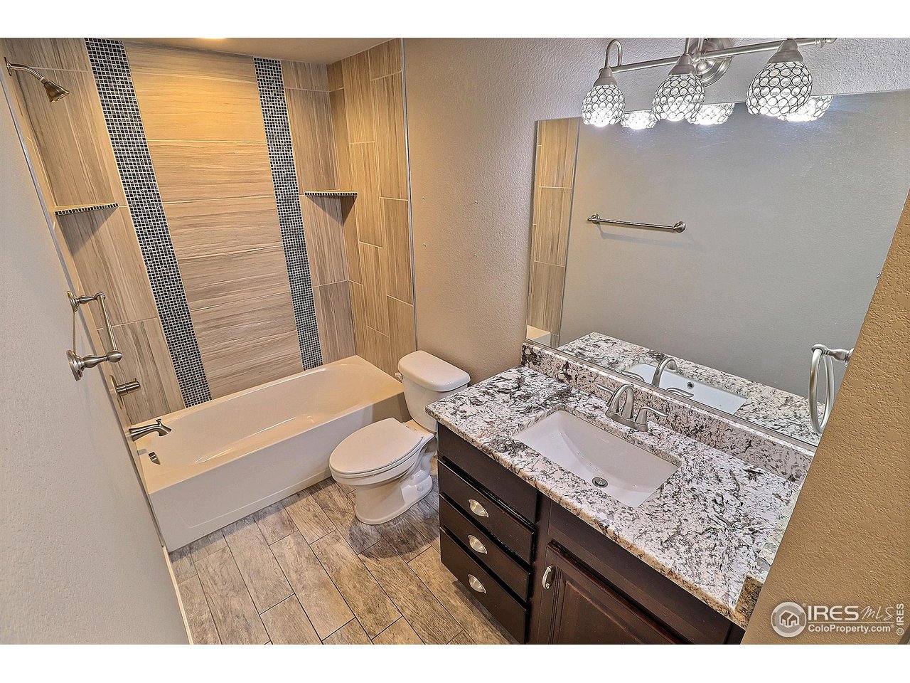 9004 19th Street Greeley, CO 80634 - Photo 44 of 49 a bathroom with a granite countertop sink toilet and shower