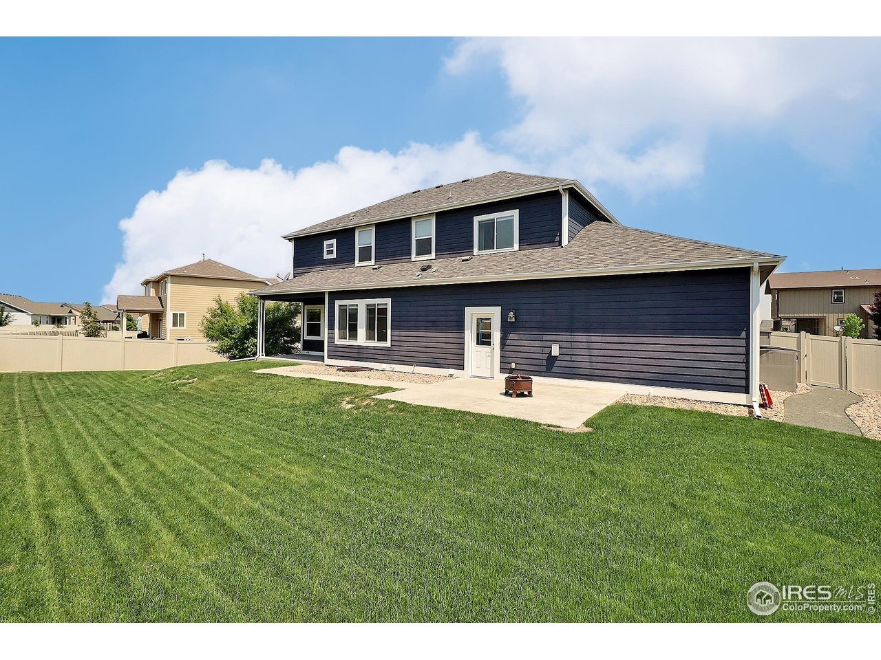 9004 19th Street Greeley, CO 80634 - Photo 45 of 49 a front view of a house with a garden