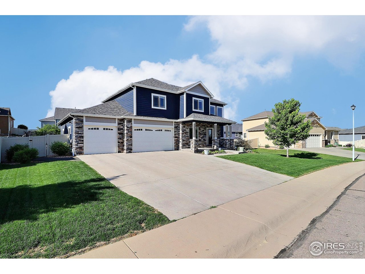 9004 19th Street Greeley, CO 80634 - Photo 47 of 49 a front view of a house with a yard and garage