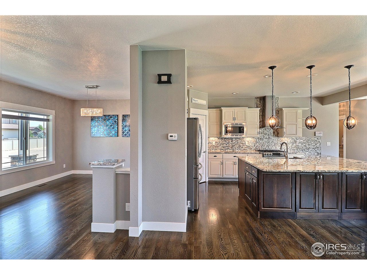 9004 19th Street Greeley, CO 80634 - Photo 6 of 49 a open kitchen with cabinets and wooden floor