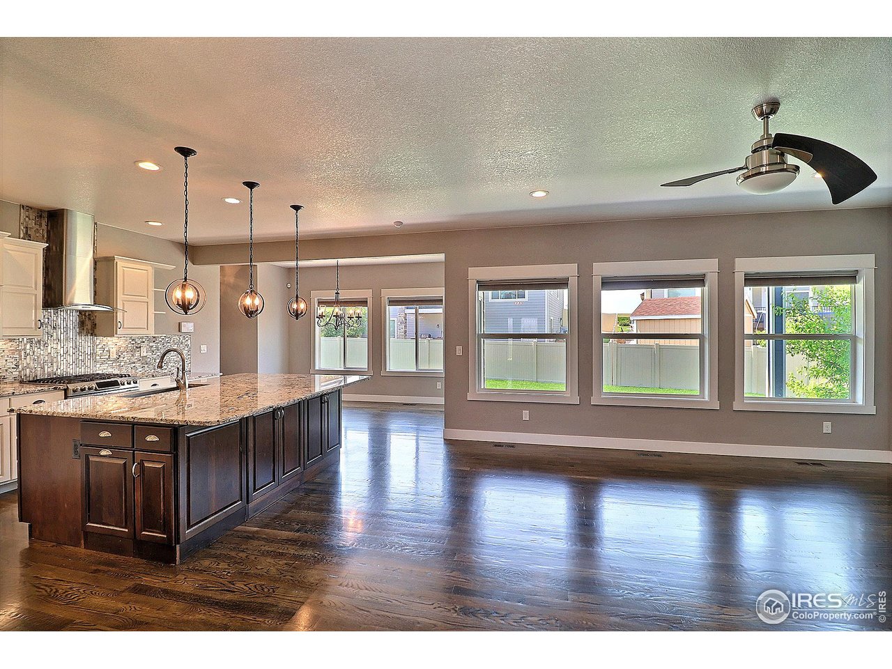 9004 19th Street Greeley, CO 80634 - Photo 7 of 49 a kitchen with stainless steel appliances granite countertop a sink a stove and a wooden floors