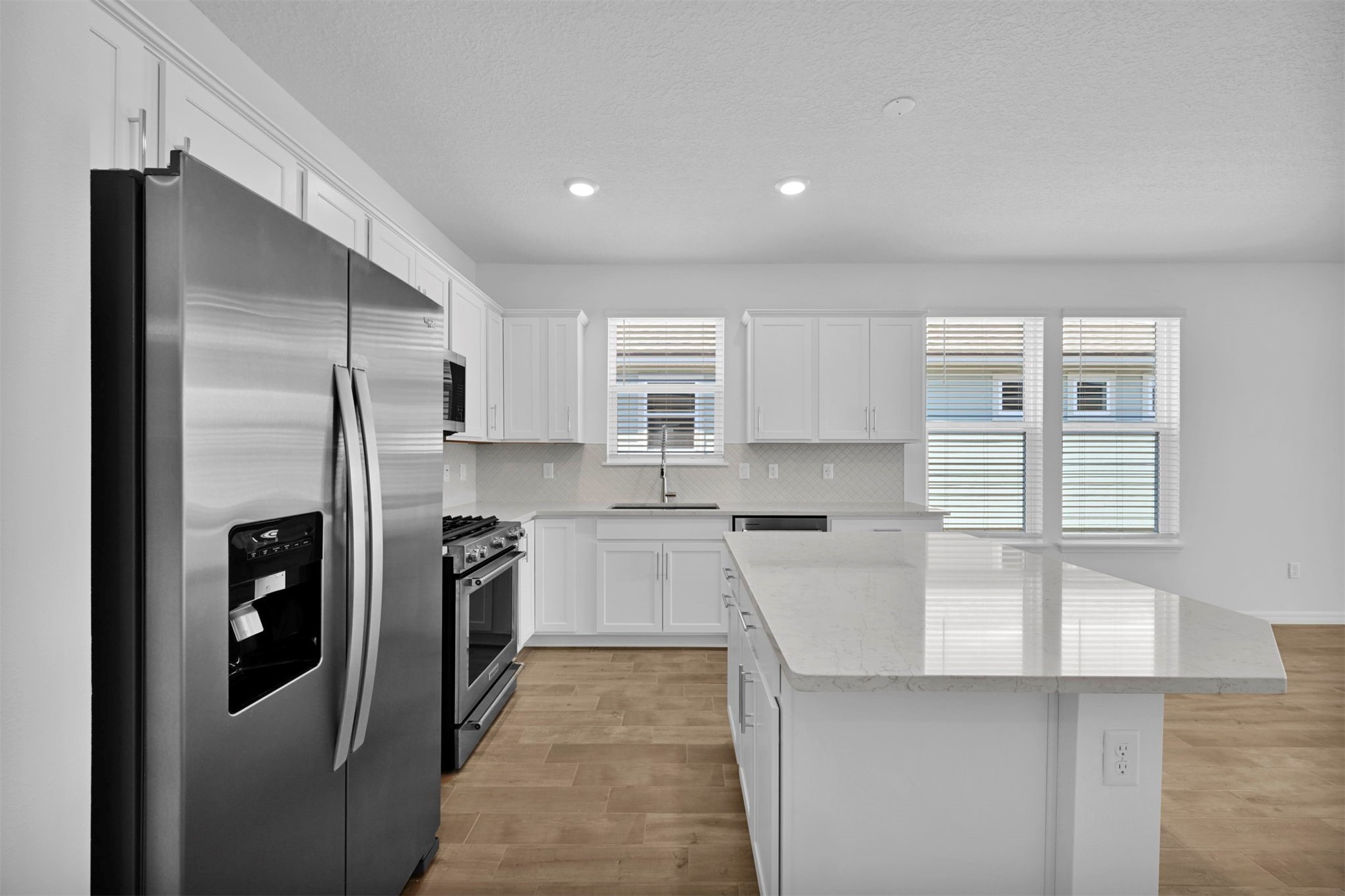285 Ecliptic Loop Yulee, FL 32097 - Photo 5 of 42 a kitchen with stainless steel appliances granite countertop a refrigerator and a stove
