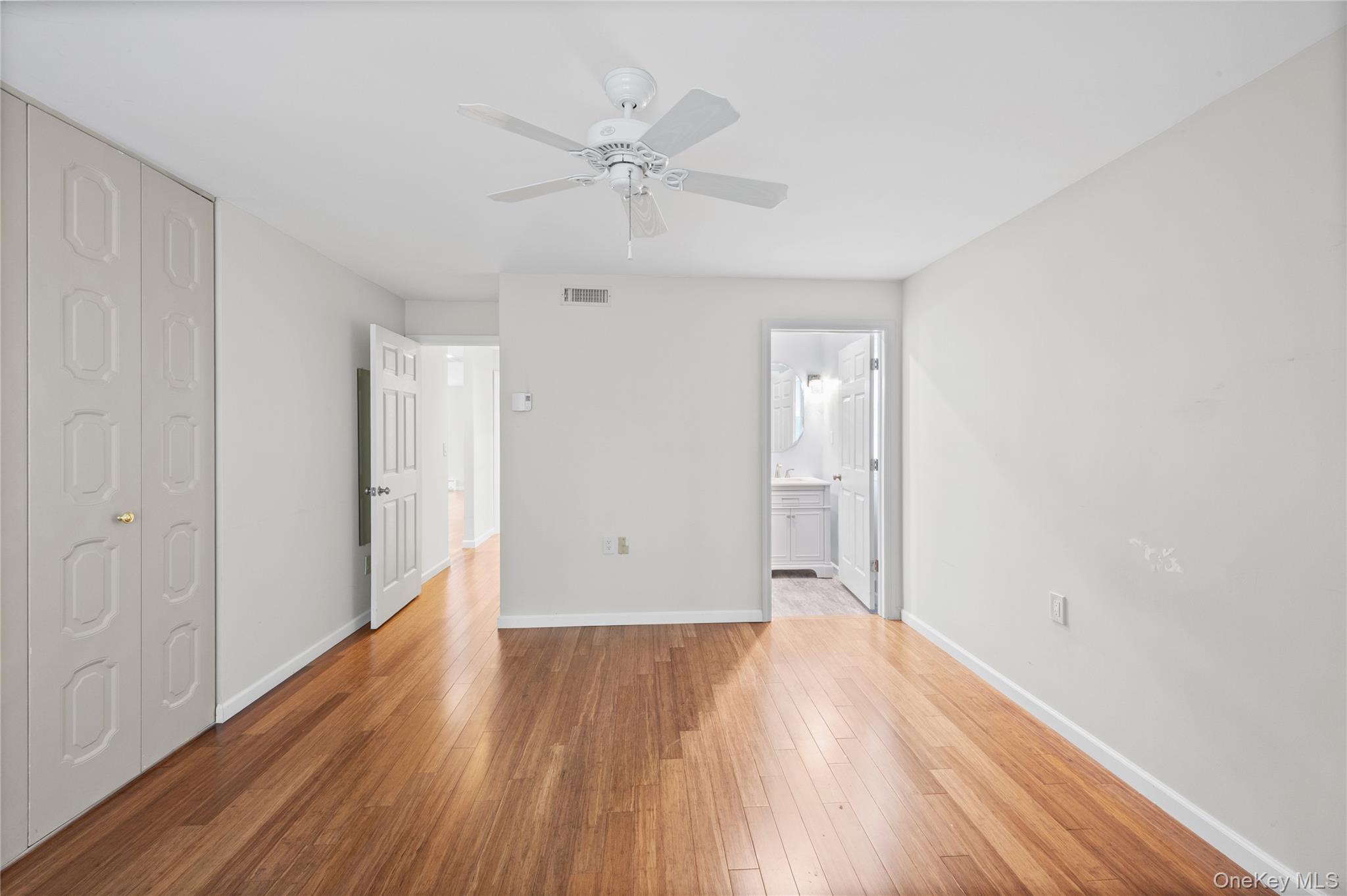 220 Belfast Lane Ridge, NY 11961 - Photo 34 of 44 a view of an empty room with wooden floor