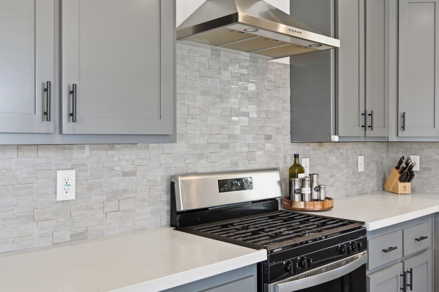 1842 Quimby Road, Unit 1842 San Jose, CA 95122 - Photo 12 of 25 a kitchen with granite countertop a stove sink and cabinets