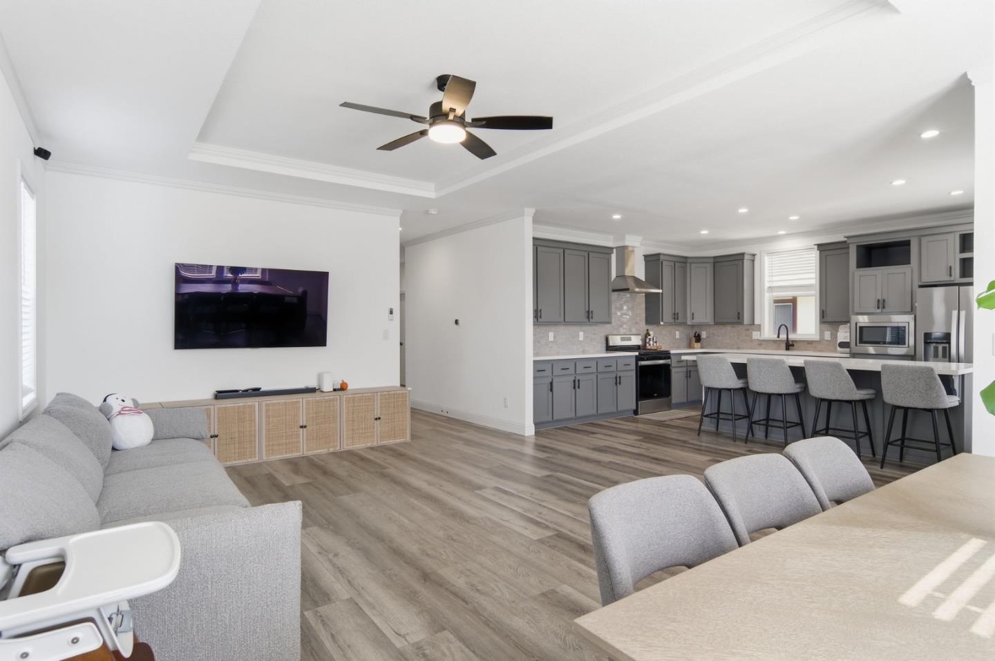 1842 Quimby Road, Unit 1842 San Jose, CA 95122 - Photo 7 of 25 a living room with furniture kitchen view and a flat screen tv