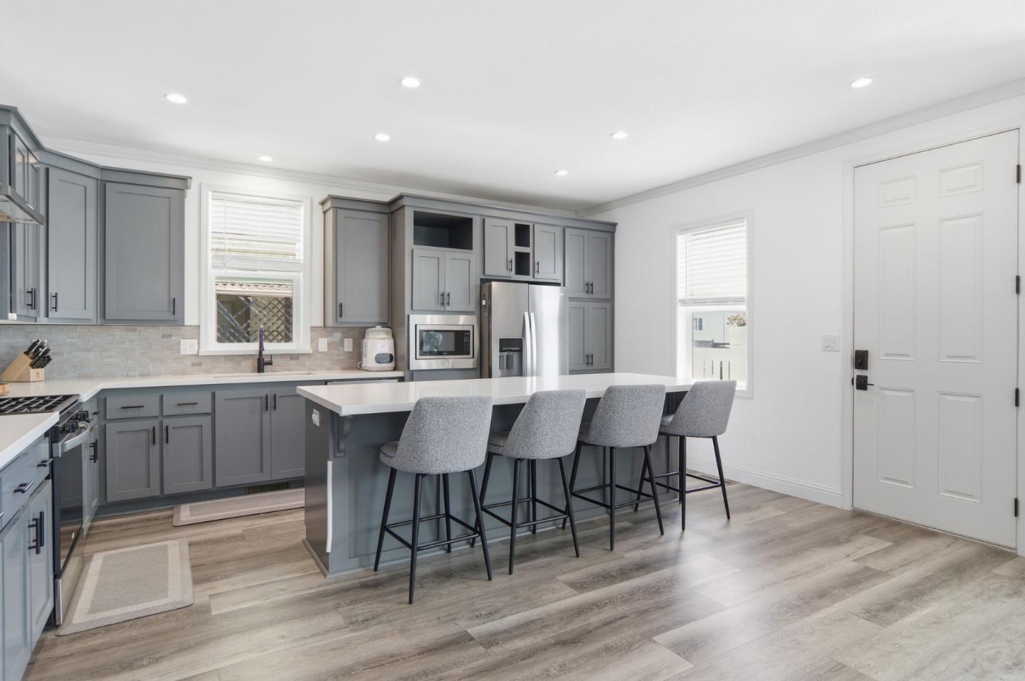 1842 Quimby Road, Unit 1842 San Jose, CA 95122 - Photo 10 of 25 a kitchen with a dining table chairs cabinets wooden floor and appliances