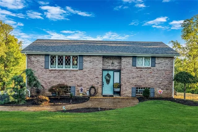 a front view of a house with a garden