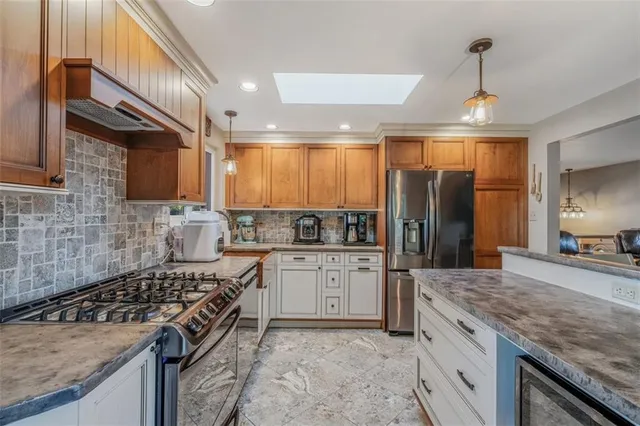 a kitchen with a stove sink and refrigerator