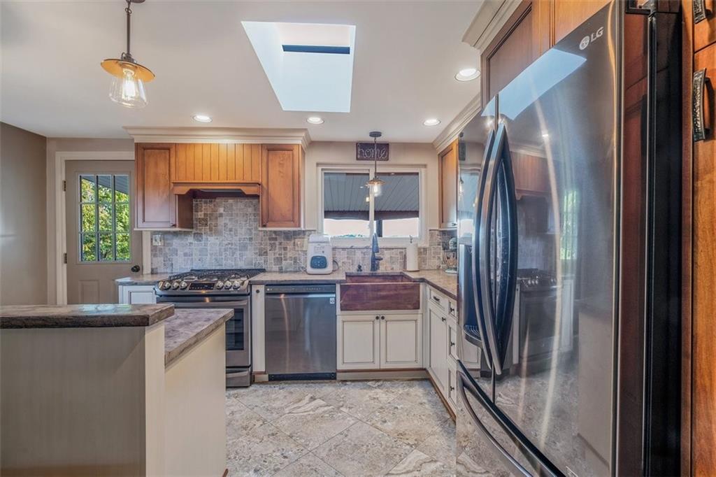 259 Christy Road Eighty Four, PA 15330 - Photo 12 of 46 a kitchen with stainless steel appliances granite countertop a refrigerator a sink a stove and white cabinets with wooden floor
