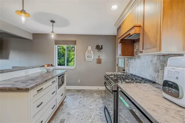 a kitchen that has a stove and a sink