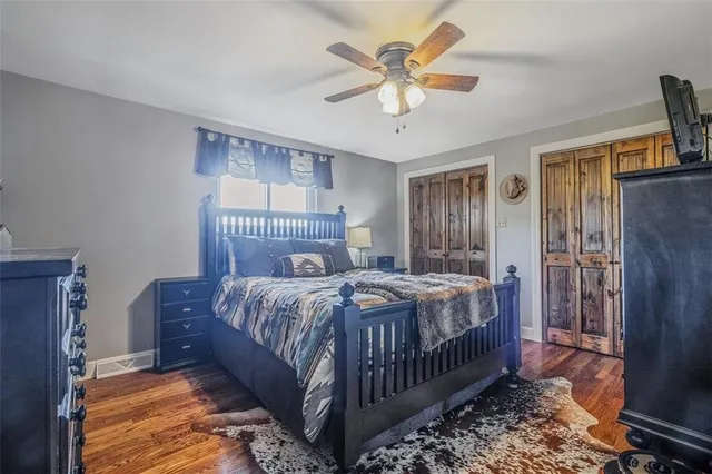a bedroom with a bed a chandelier and dresser