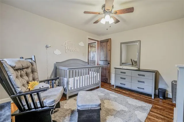 a view of staircase with furniture and ceiling fan