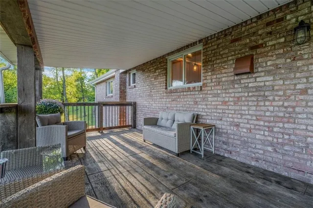 a balcony with wooden floor and furniture