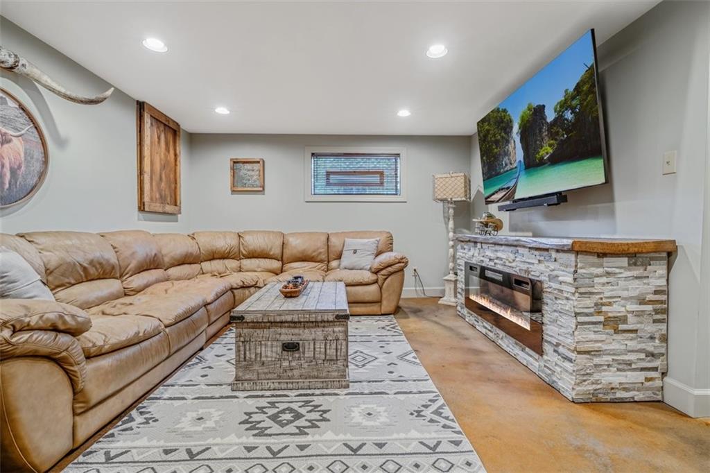 259 Christy Road Eighty Four, PA 15330 - Photo 34 of 46 a living room with furniture a flat screen tv and a fireplace