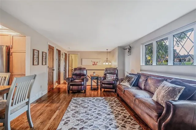 a living room with furniture rug and window