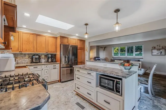 a kitchen with stainless steel appliances granite countertop a stove and a sink
