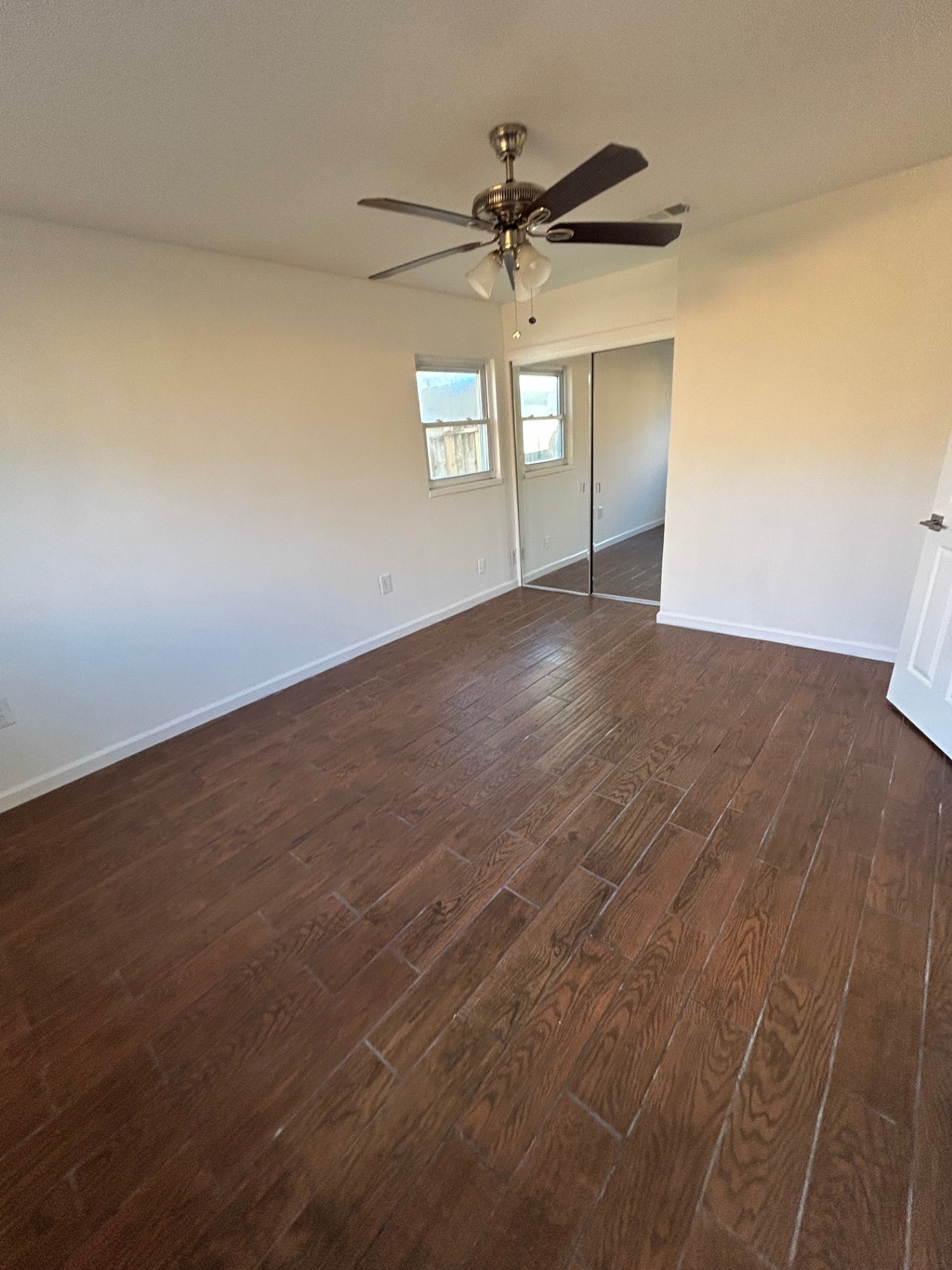 1922 Vassar Street Houston, TX 77098 - Photo 16 of 27 an empty room with wooden floor fan and windows