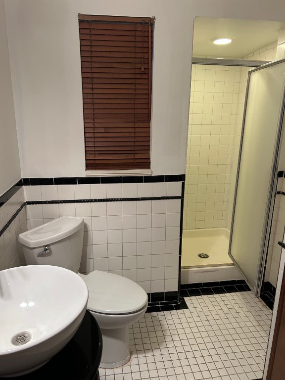 1922 Vassar Street Houston, TX 77098 - Photo 17 of 27 Bath has a tiled shower stall and tile floors.