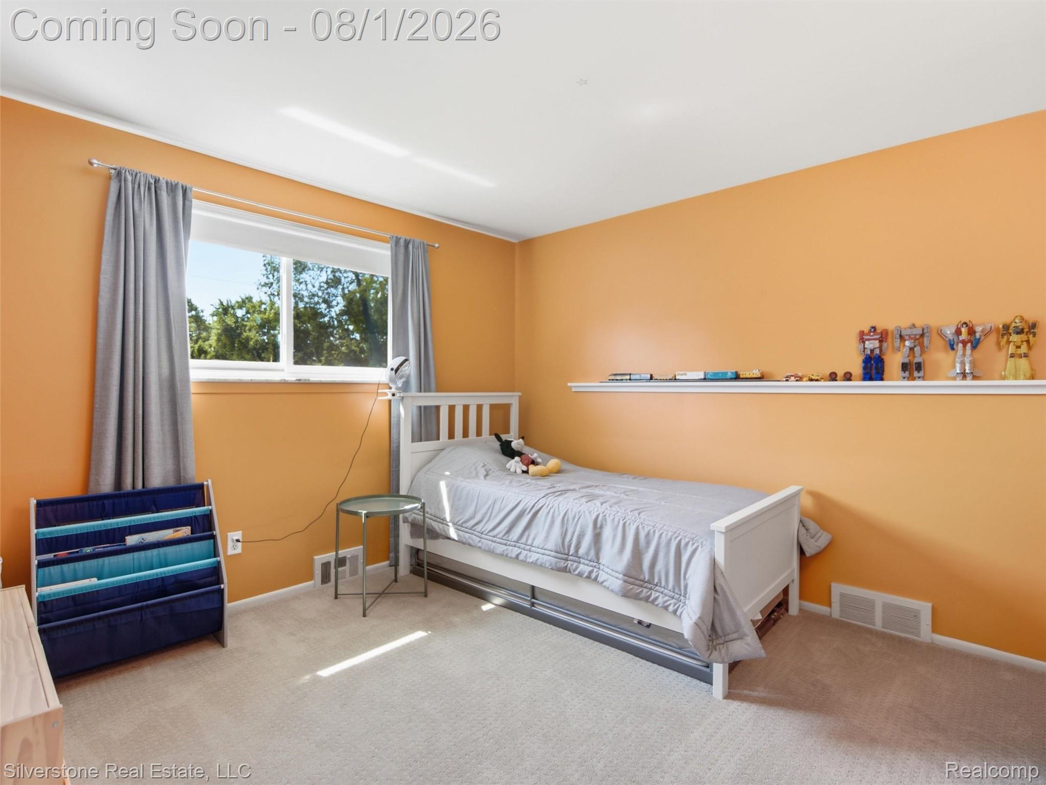 2135 Wayward Drive Rochester, MI 48309 - Photo 30 of 55 Room featuring a large window with white trim, light-colored carpeting, a wall-mounted display shelf, and light orange wall paint