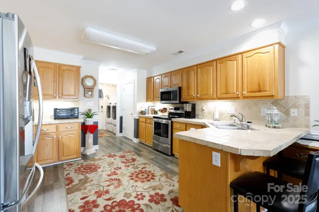 a kitchen with a sink stove and refrigerator