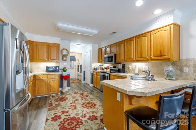 a kitchen with a refrigerator and a stove top oven