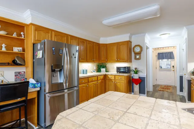 a kitchen with stainless steel appliances a refrigerator and a stove top oven