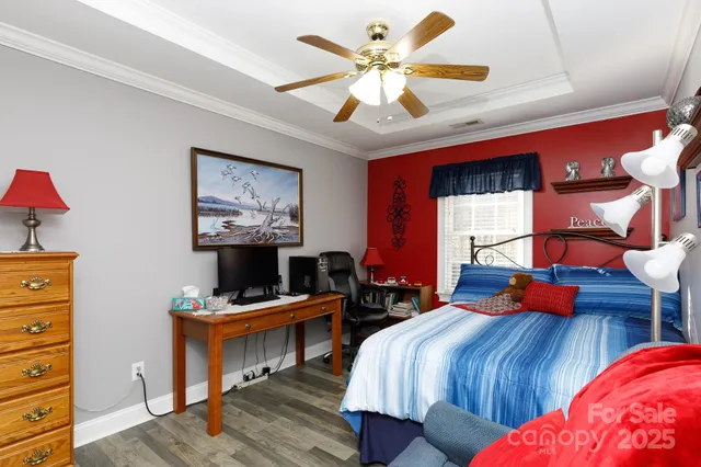 a bedroom with a bed and a chandelier