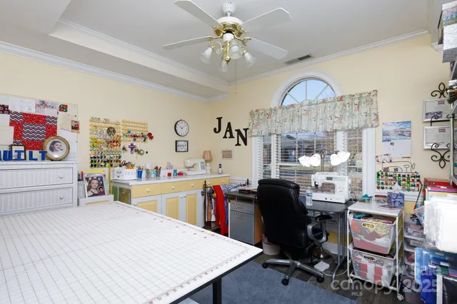 a view of a workspace with furniture and a kitchen