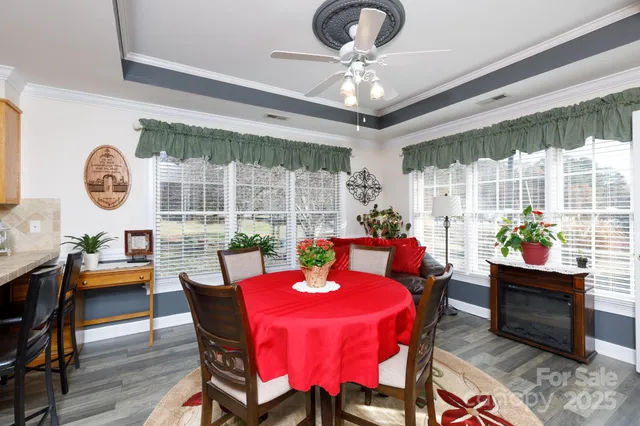 a dining room with furniture a rug and a large window
