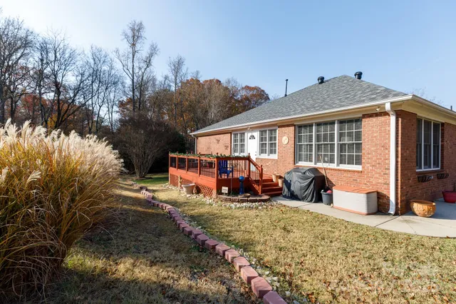 a view of a patio with couches table and chairs and potted plants