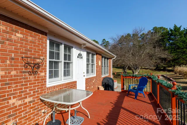 a balcony with wooden floor and furniture