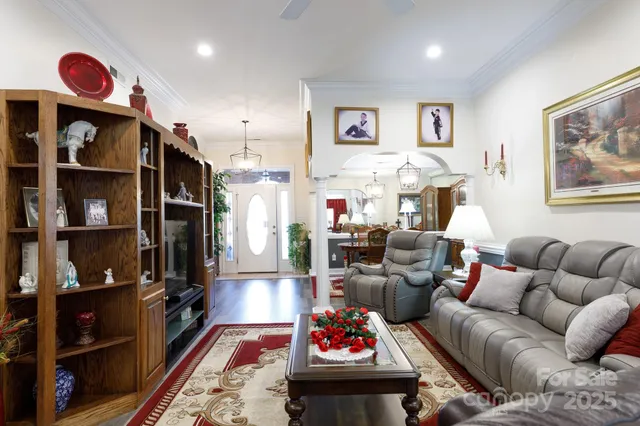 a living room with furniture a rug and a book shelf