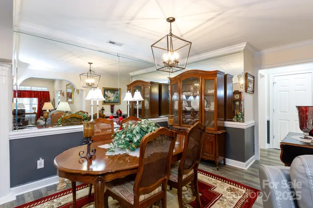 a view of a dining room with furniture and chandelier