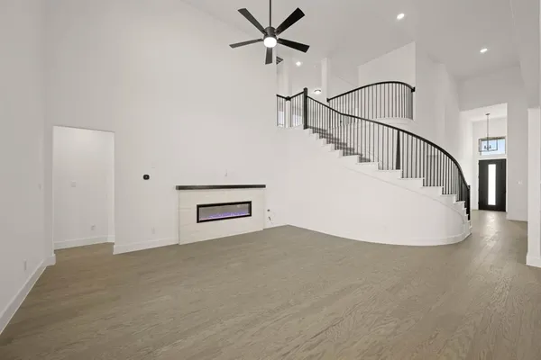 a view of a livingroom with wooden floor and white walls