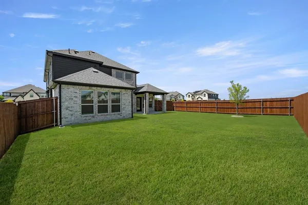 a view of a house with a yard and sitting area