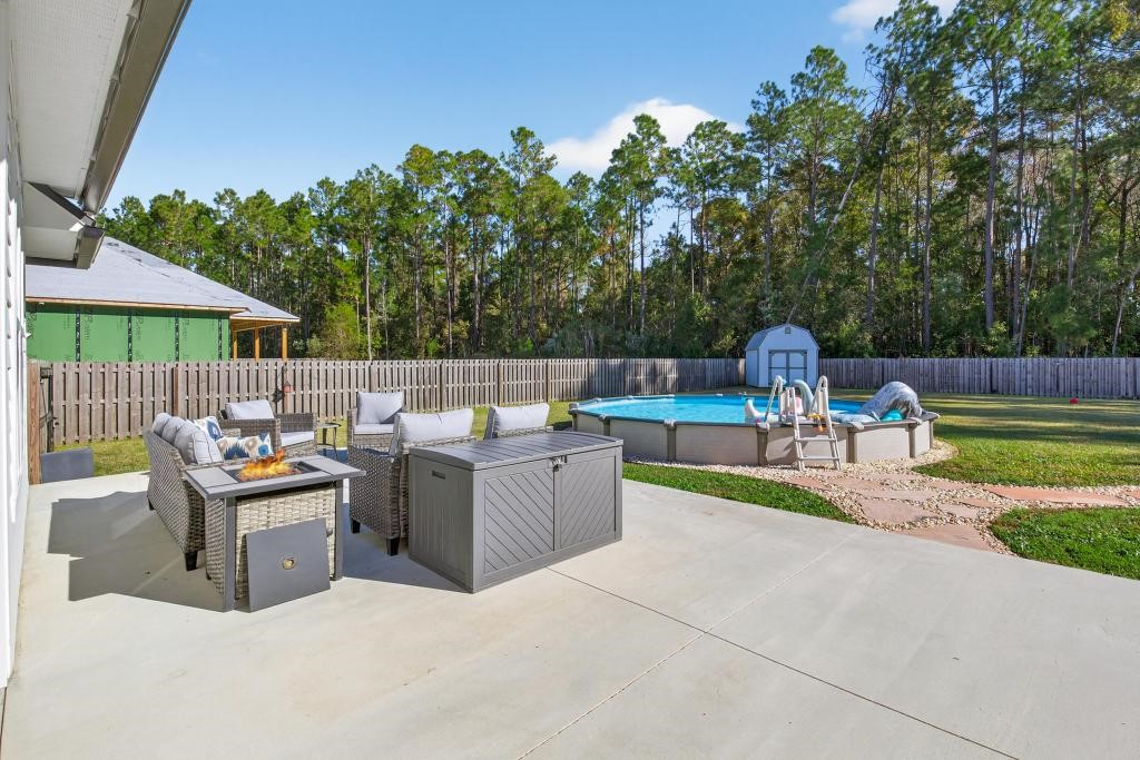 75774 Edwards Road Yulee, FL 32097 - Photo 51 of 70 a view of a patio with a chairs and table in a patio